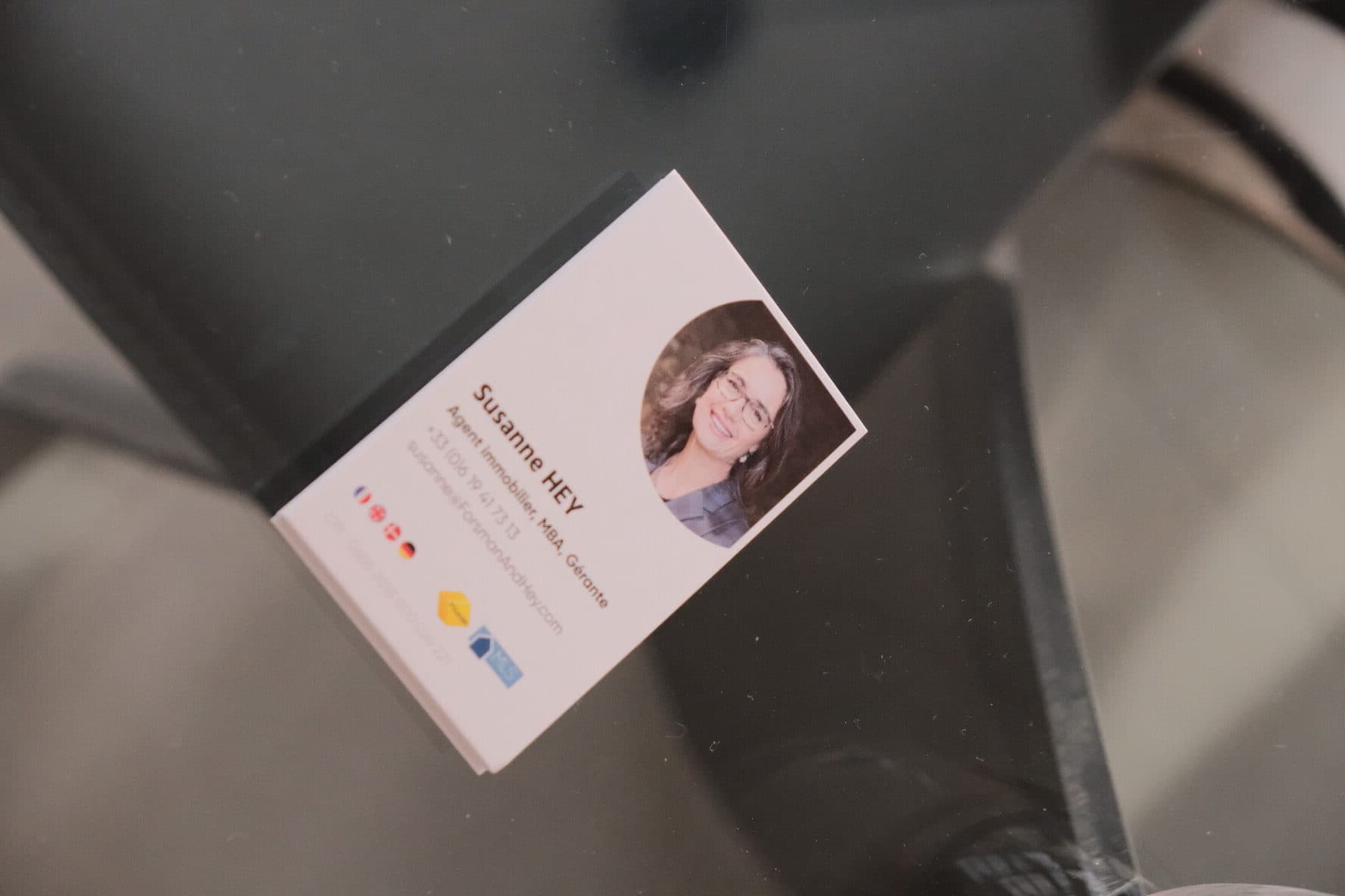 The agency's business card on a glass table