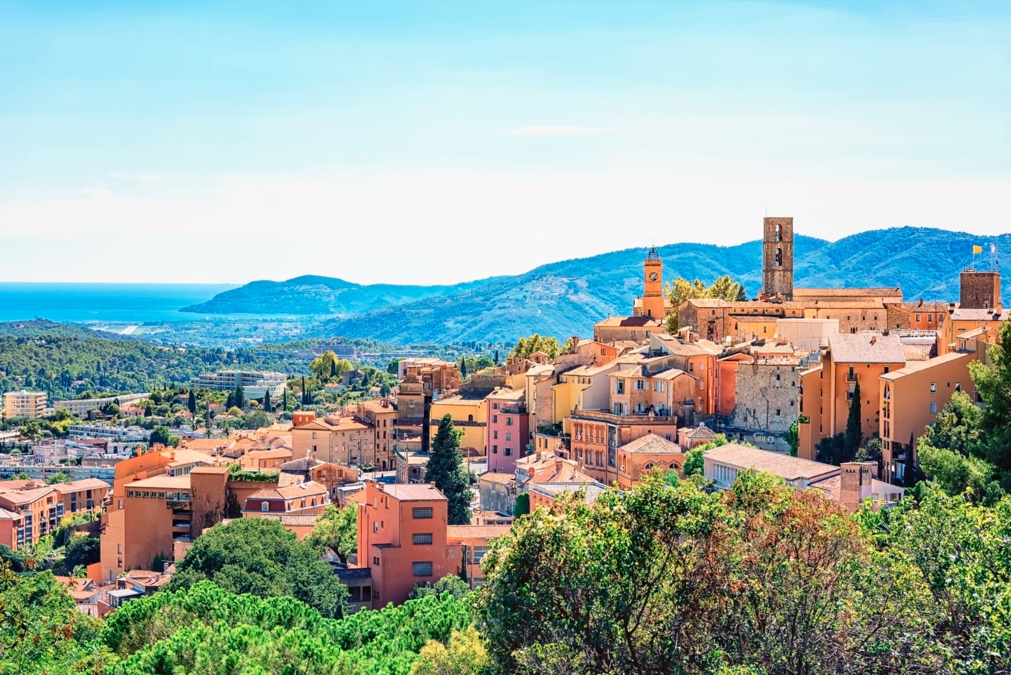 The old town of Grasse and its cathedral, above the hills and the bay